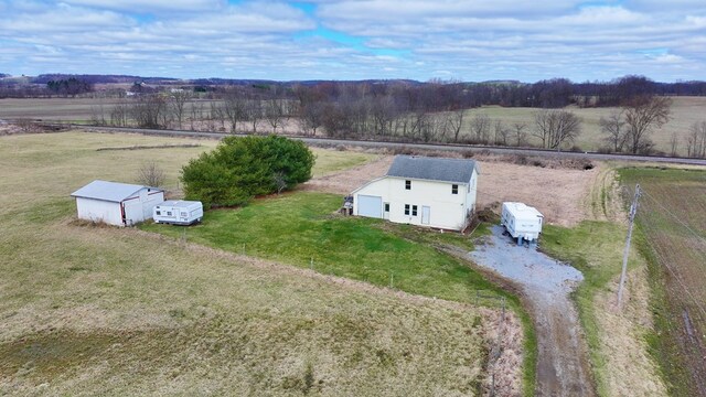 birds eye view of property with a rural view
