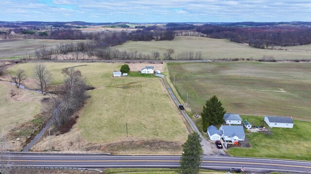 birds eye view of property with a rural view
