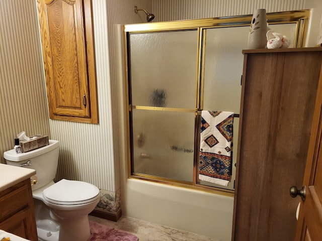 full bathroom featuring shower / bath combination with glass door, vanity, and toilet