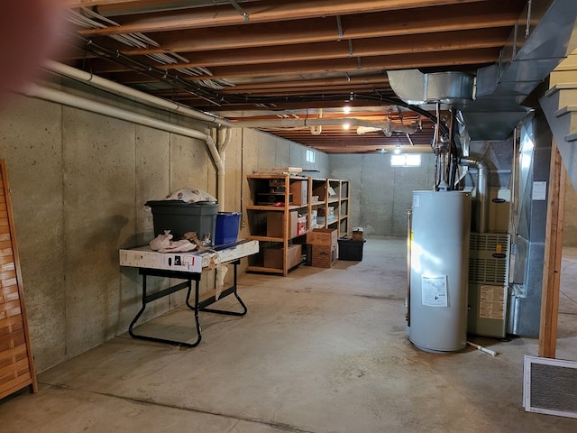 basement featuring electric water heater and heating unit