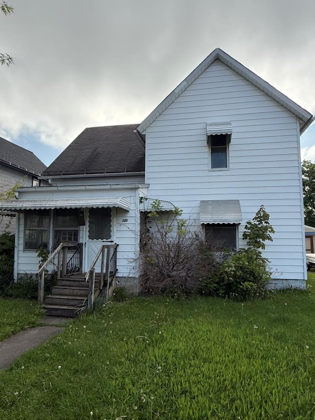 379 N Wiley St, Crestline, OH 44827 - view of front of house featuring a front yard and a shingled roof