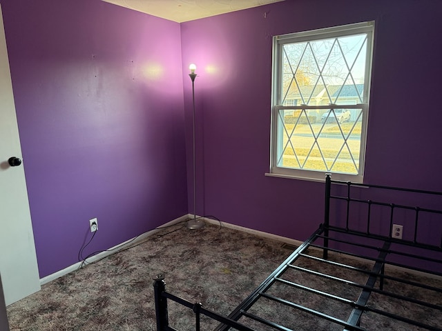 unfurnished bedroom featuring baseboards and carpet floors