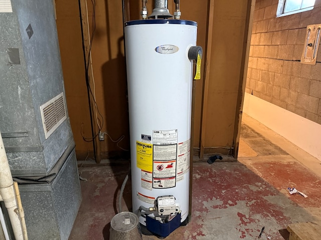 utility room with heating unit and gas water heater