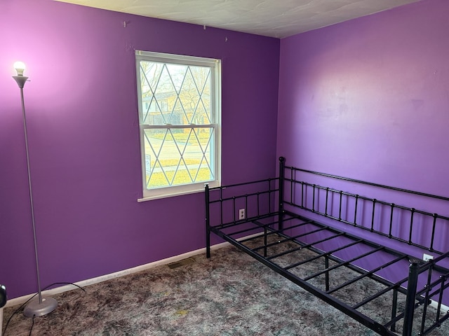 carpeted bedroom featuring baseboards