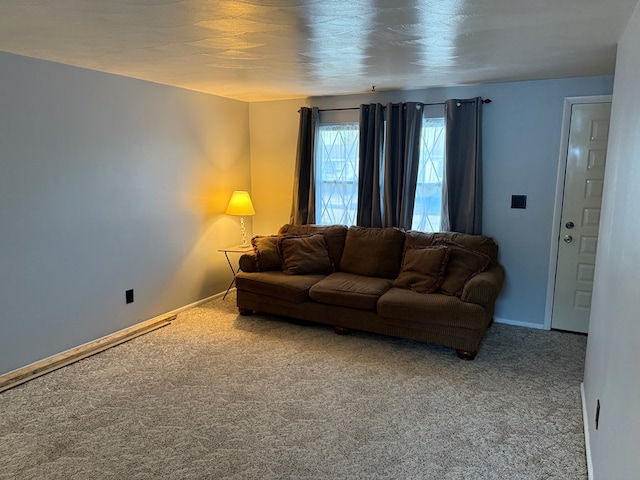 carpeted living area featuring baseboards