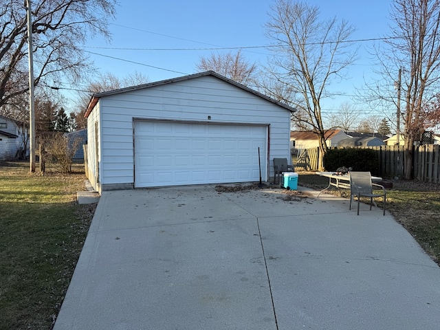 detached garage featuring fence