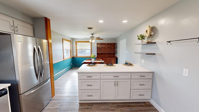 kitchen featuring white cabinets, ceiling fan, kitchen peninsula, and appliances with stainless steel finishes