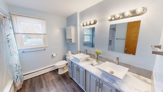 full bathroom with hardwood / wood-style flooring, plenty of natural light, vanity, and a baseboard radiator