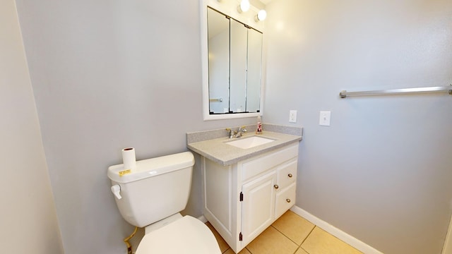 bathroom featuring tile patterned flooring, vanity, and toilet