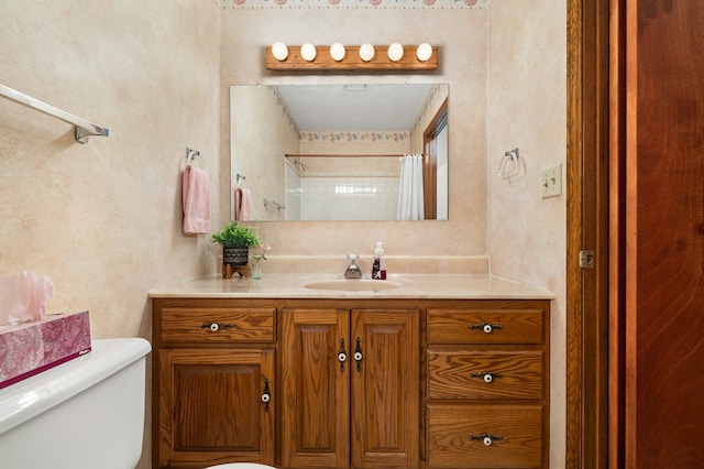 bathroom featuring vanity, curtained shower, and toilet