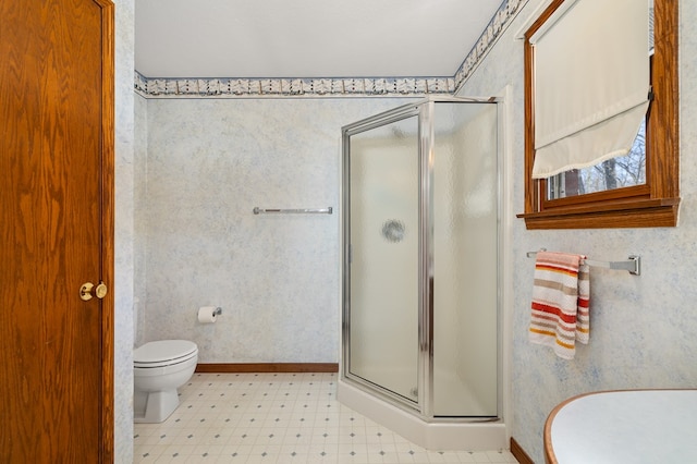 bathroom with an enclosed shower and toilet