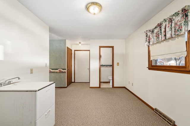 carpeted empty room with sink