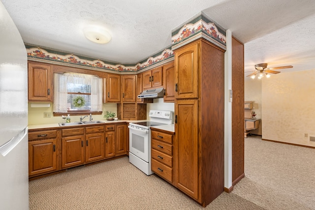 kitchen featuring sink, white appliances, a textured ceiling, ceiling fan, and light colored carpet