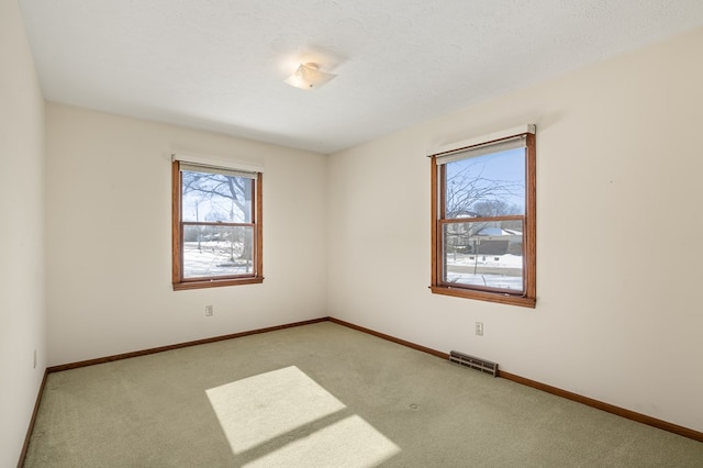 unfurnished room with light carpet