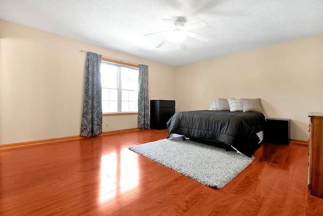 bedroom with ceiling fan and hardwood / wood-style floors