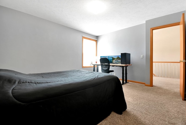 carpeted bedroom featuring a textured ceiling