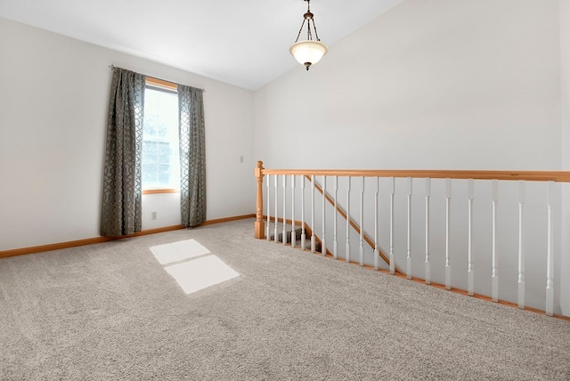 unfurnished room with carpet floors and lofted ceiling