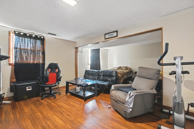 living area featuring baseboards and wood finished floors