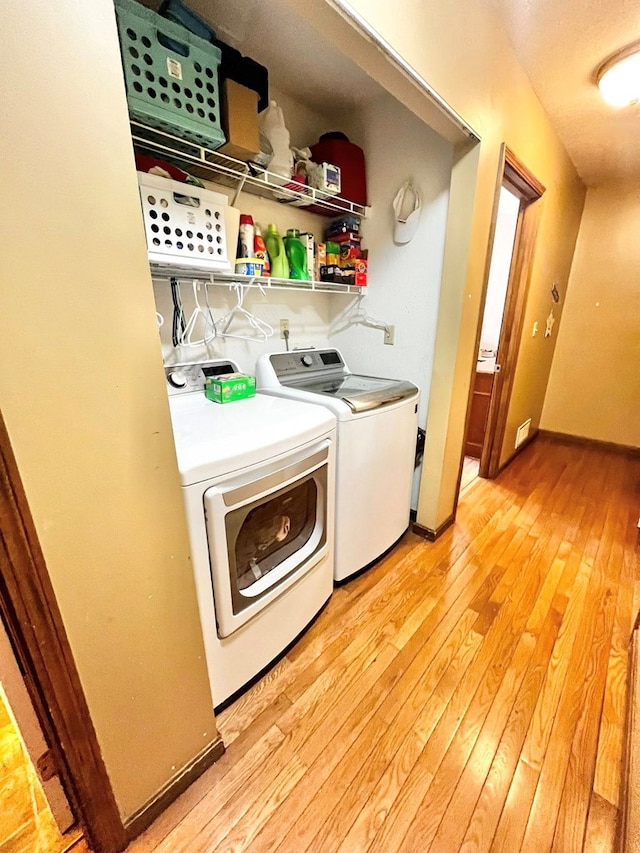 352 Valleybrook Cir, Howard, OH 43028 - washroom with washer and clothes dryer and light wood finished floors