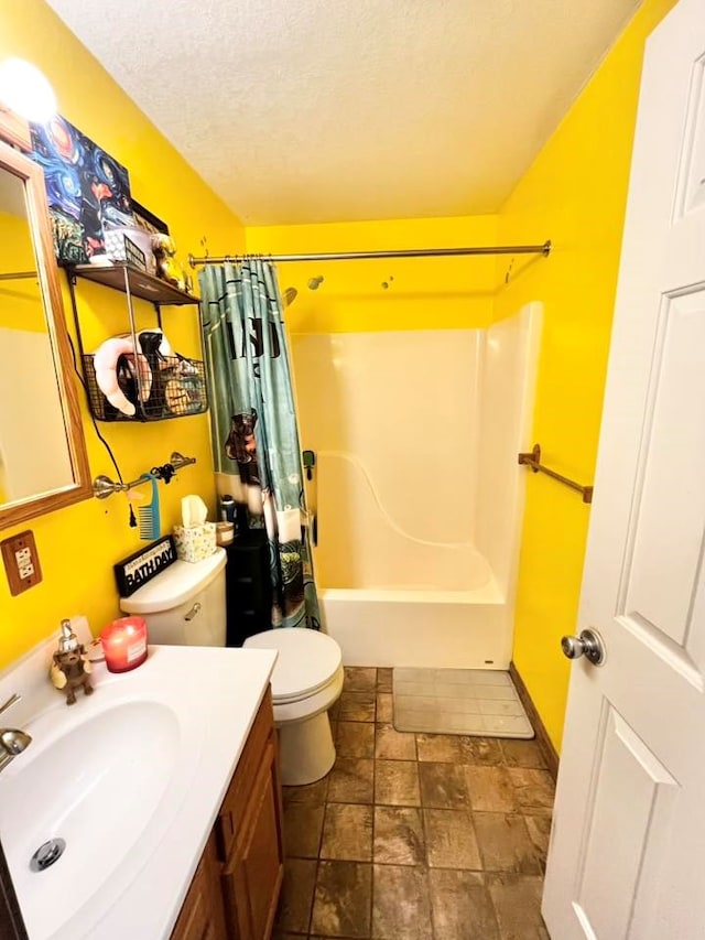 352 Valleybrook Cir, Howard, OH 43028 - full bathroom featuring toilet, shower / tub combo, stone finish floors, vanity, and a textured ceiling