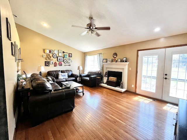 352 Valleybrook Cir, Howard, OH 43028 - living room featuring ceiling fan, wood-type flooring, lofted ceiling, a fireplace with raised hearth, and french doors