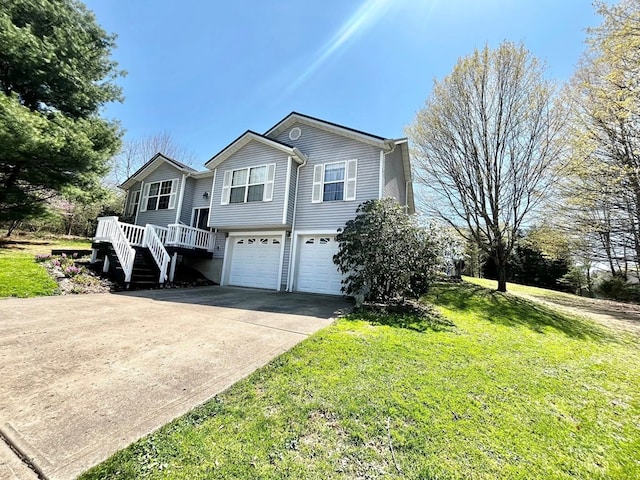 352 Valleybrook Cir, Howard, OH 43028 - split foyer home featuring a garage, driveway, a front lawn, and stairway