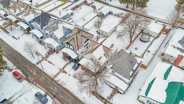 snowy aerial view featuring a residential view