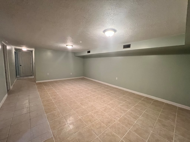 basement featuring a textured ceiling