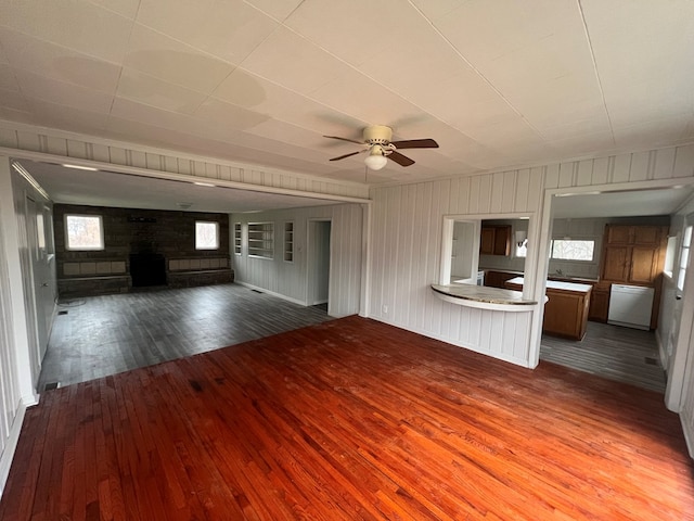 unfurnished living room featuring ceiling fan and wood-type flooring