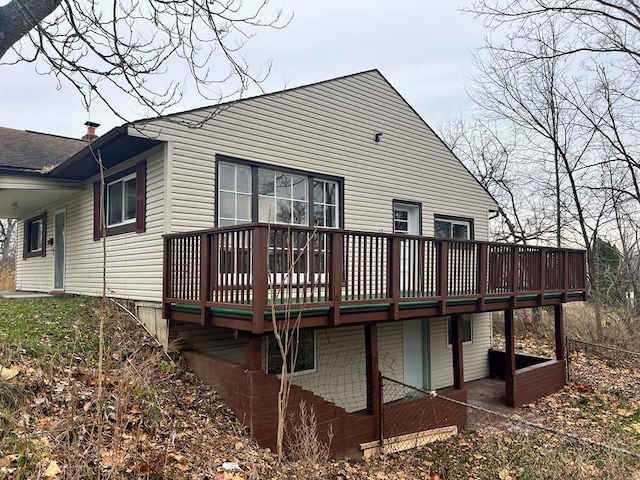 rear view of property featuring a deck