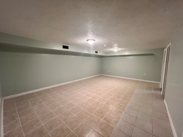 basement featuring a textured ceiling