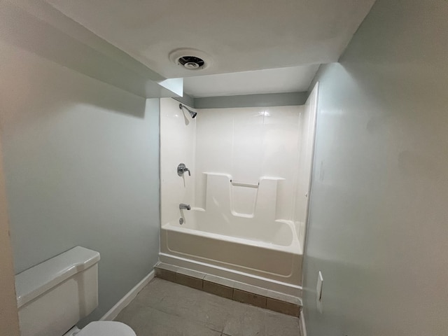 bathroom featuring toilet, tile patterned flooring, and bathing tub / shower combination