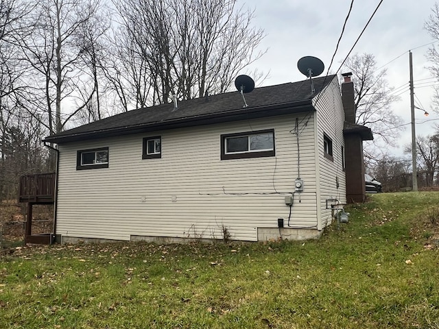 view of property exterior with a yard