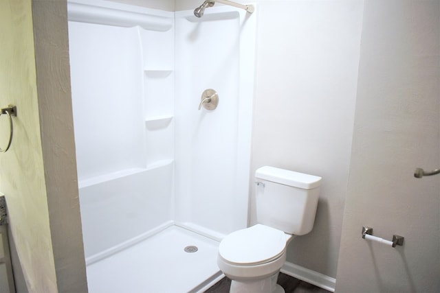 bathroom with walk in shower and toilet