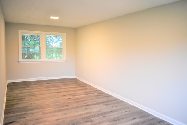 unfurnished room featuring wood-type flooring