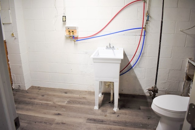 bathroom featuring toilet and wood-type flooring