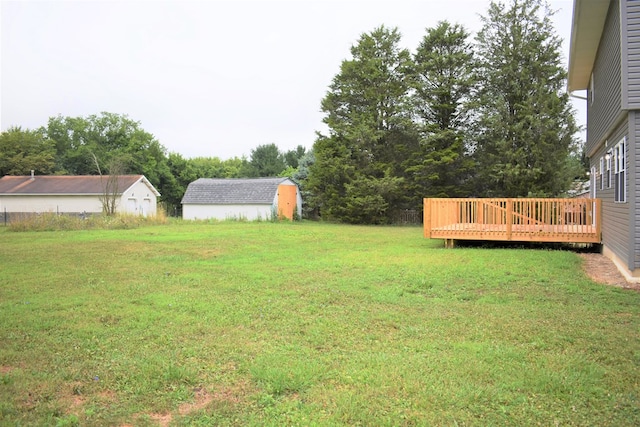 view of yard with a storage shed and a wooden deck