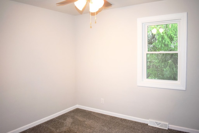 carpeted spare room with ceiling fan