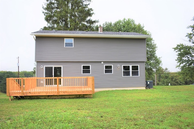 rear view of property with a lawn and a deck