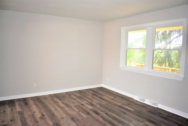 empty room with dark hardwood / wood-style floors