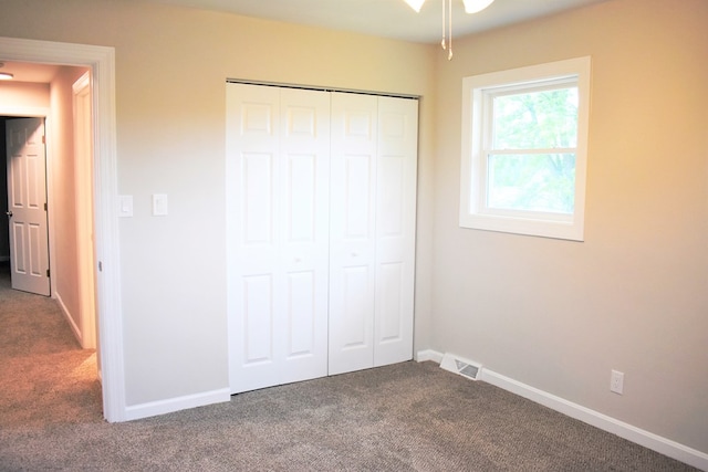 unfurnished bedroom with a closet and carpet