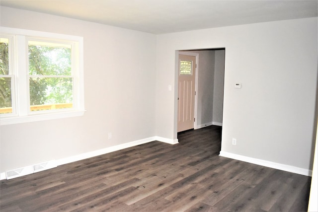 spare room featuring dark hardwood / wood-style floors