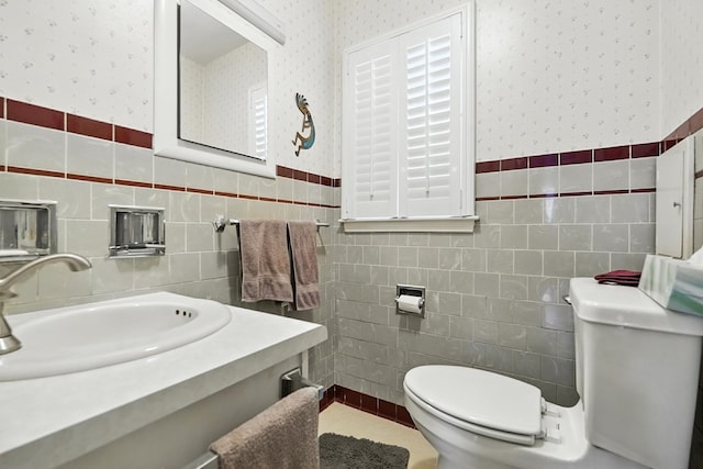 501 Overlook Rd, Mansfield, OH 44907 - bathroom with tile walls, wallpapered walls, wainscoting, and vanity