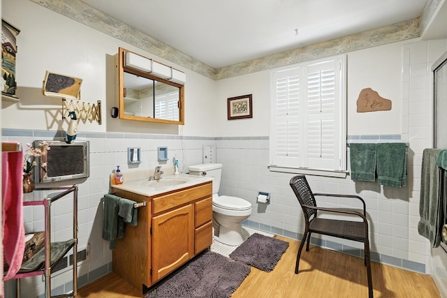 501 Overlook Rd, Mansfield, OH 44907 - full bath with tile walls, wood finished floors, vanity, a wainscoted wall, and a shower