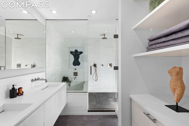 bathroom with tile patterned floors, a shower with door, and vanity