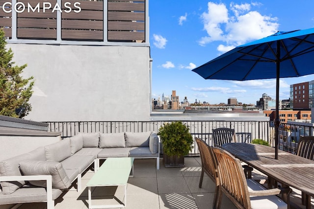 view of patio featuring a balcony and an outdoor hangout area