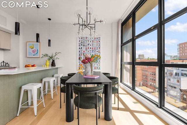 dining room featuring a healthy amount of sunlight and floor to ceiling windows