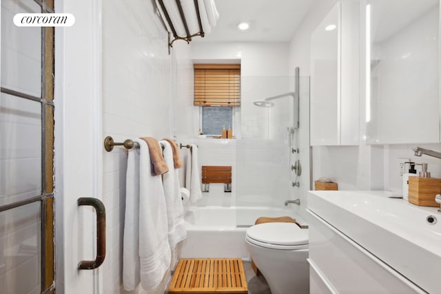 full bathroom featuring toilet, vanity, and shower / bath combination with glass door