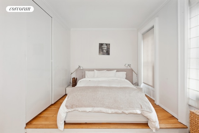 bedroom featuring hardwood / wood-style flooring and ornamental molding