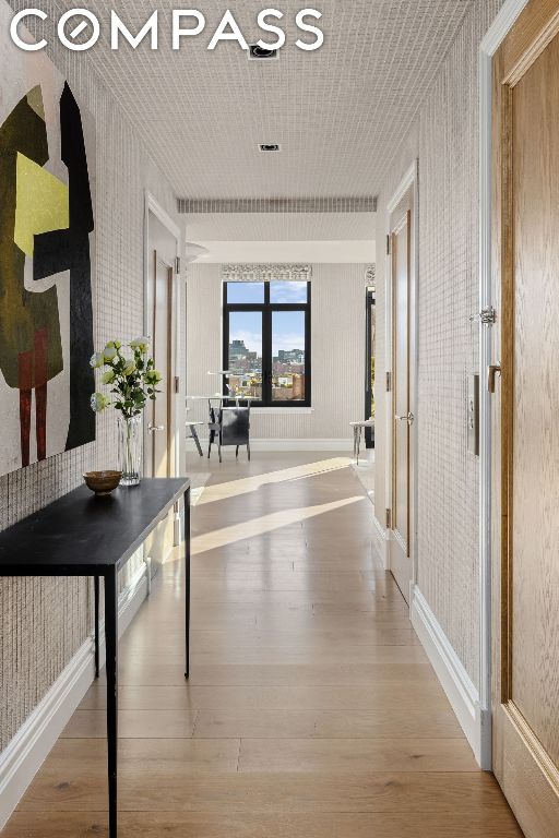 corridor with hardwood / wood-style flooring